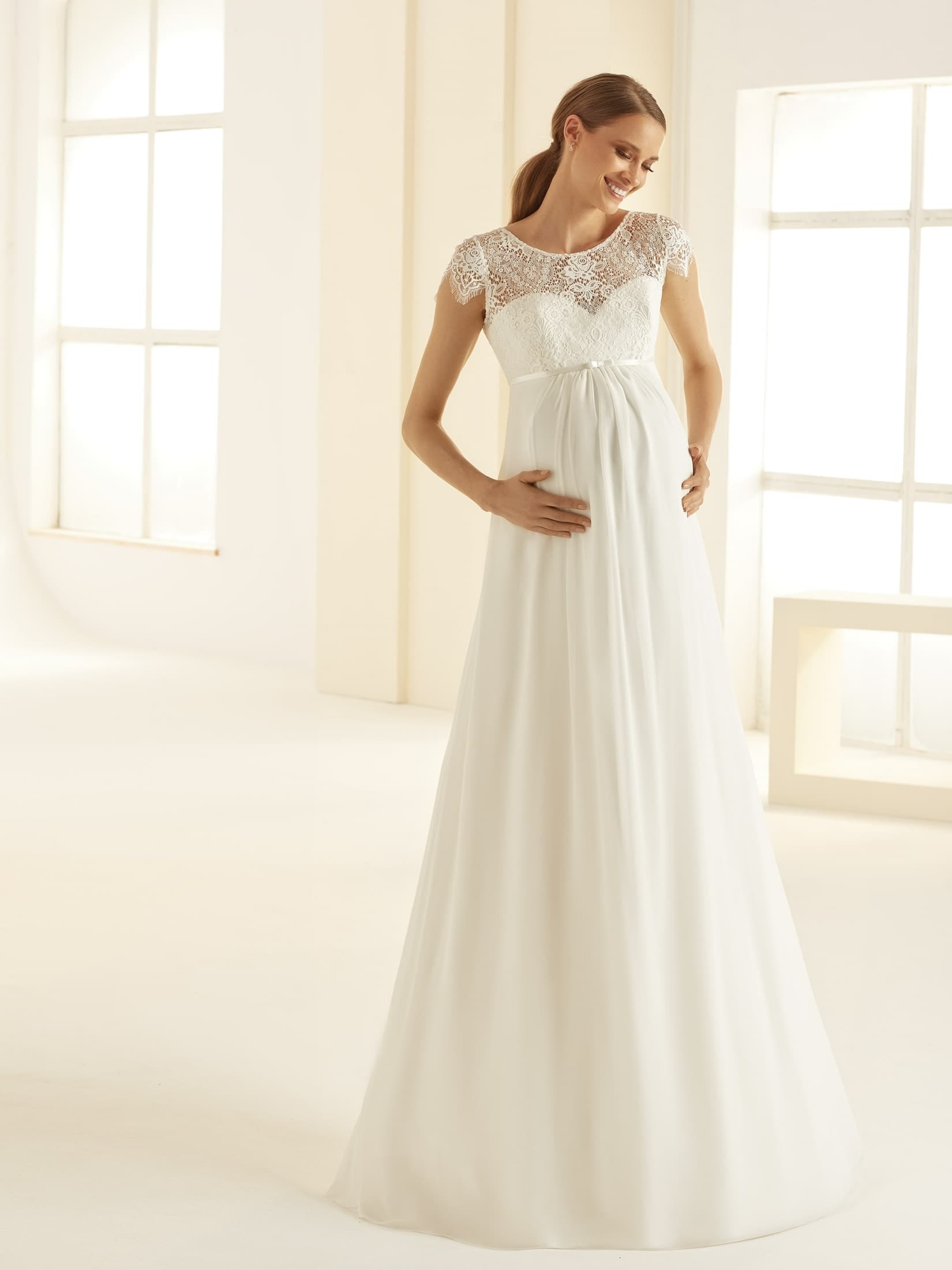 Obrázek ženy se svatebními šaty Bernadette od značky Bianco Evento